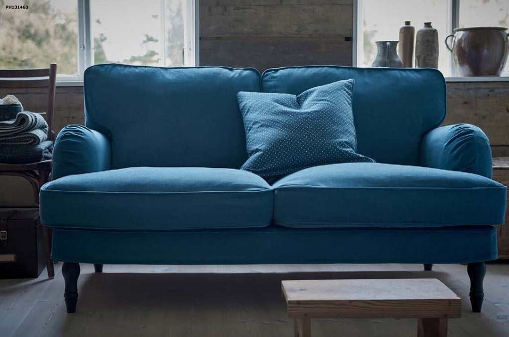 We're kind of obsessed with the moody color of this affordable loveseat ($679) and cover ($239).