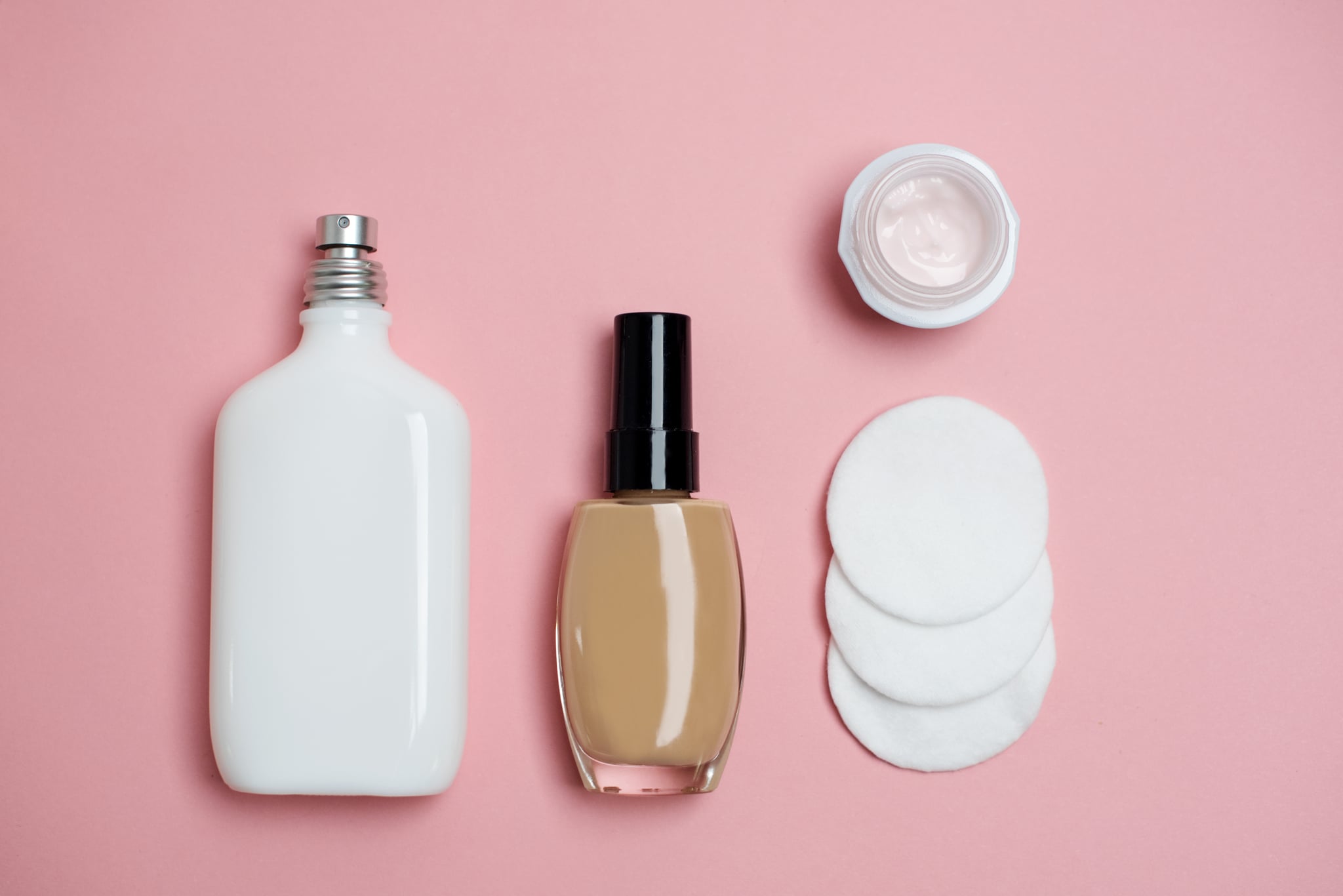 Variety of beauty products on pink background