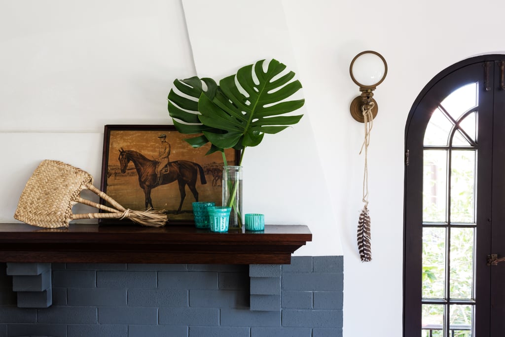 Lizzie keeps it low-key on the mantel with a jockey print from a Claremont, CA, antiques shop and palm fronds snipped from the yard.