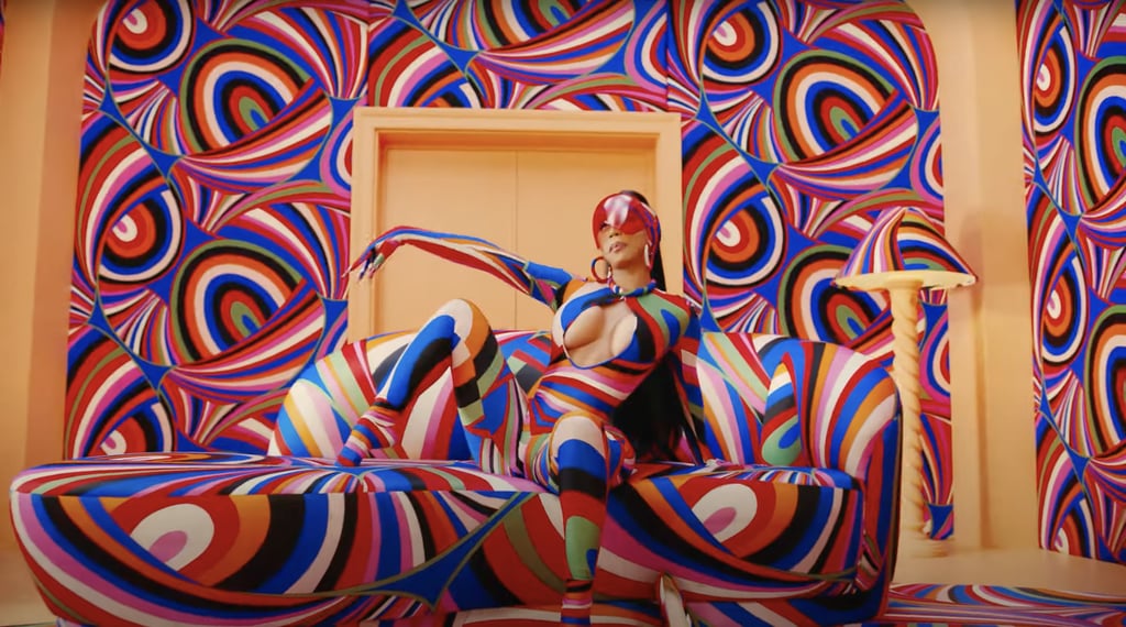 Cardi slips into a custom Pucci bodysuit and a red Selfhood visor to dance in a room covered in the same Pucci print.