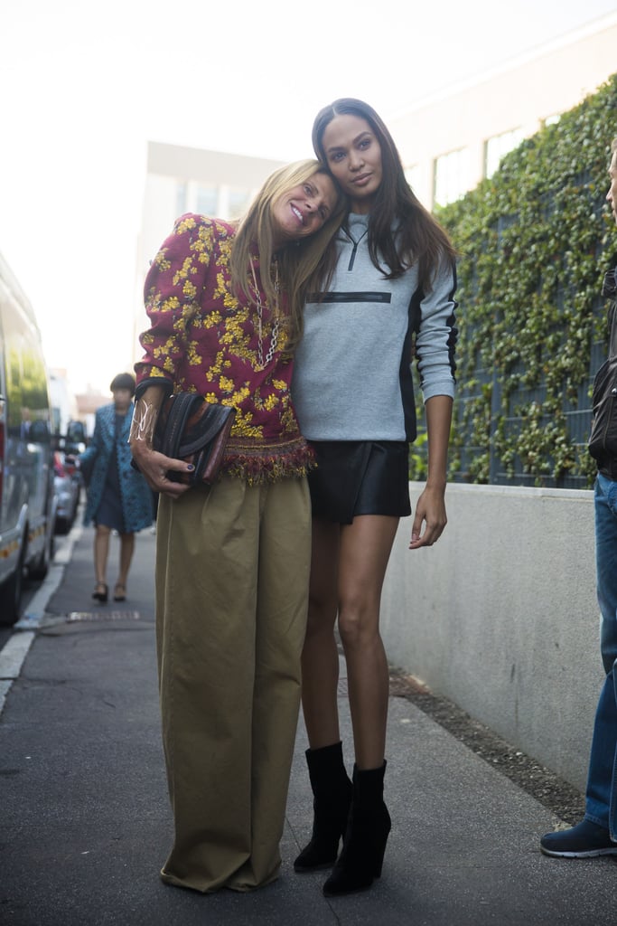 Teaching the world how to wear a workout sweatshirt to Fashion Week, Joan hugged fashion editor Anna Dello Russo for pictures.