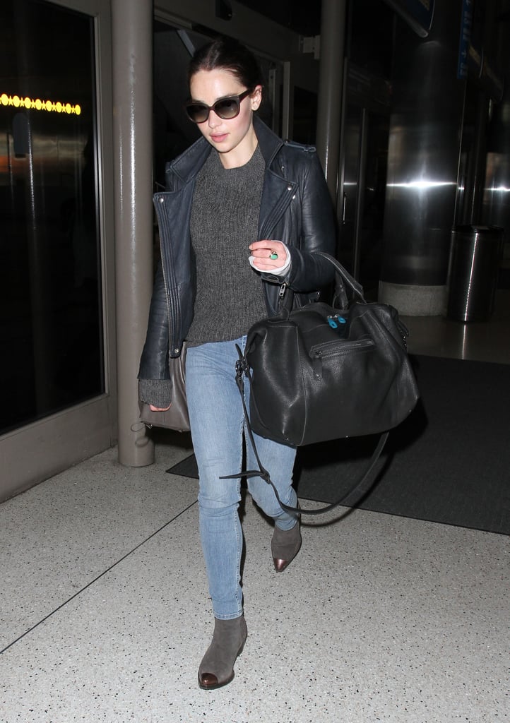 Emilia Clarke kept her style palette dark at LAX. She paired a gray sweater with a leather biker jacket, skinny denim, and cap-toe booties.