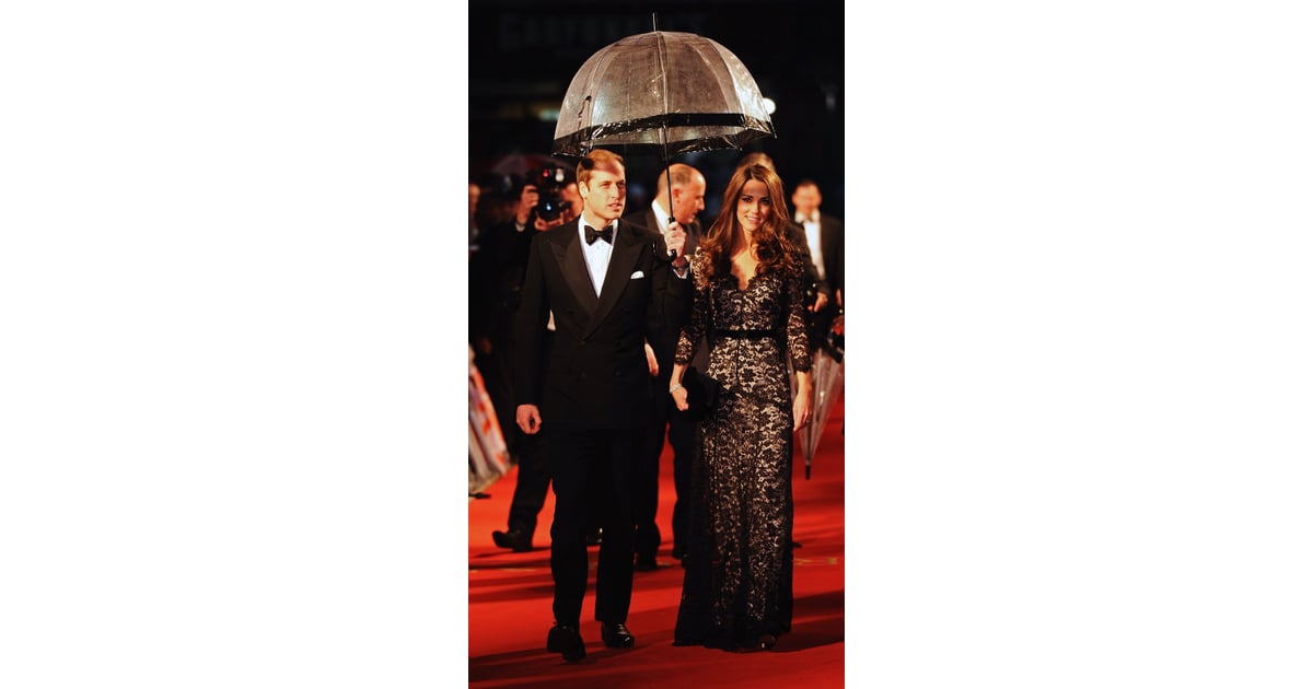 Prince William held an umbrella over Kate's head as they ...