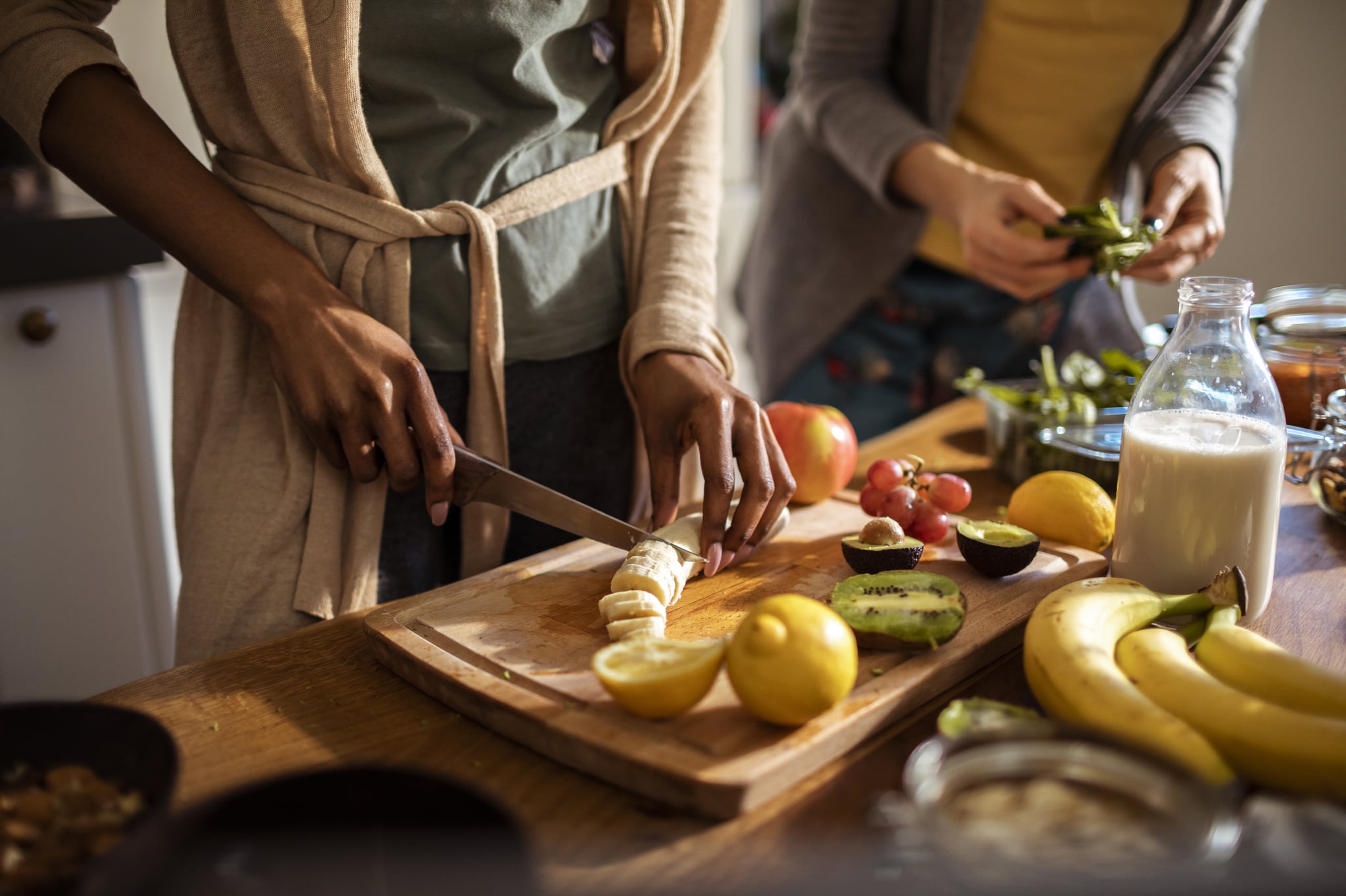 women making recipes by ingredients in their kitchen after googling: what can i make with these ingredients?