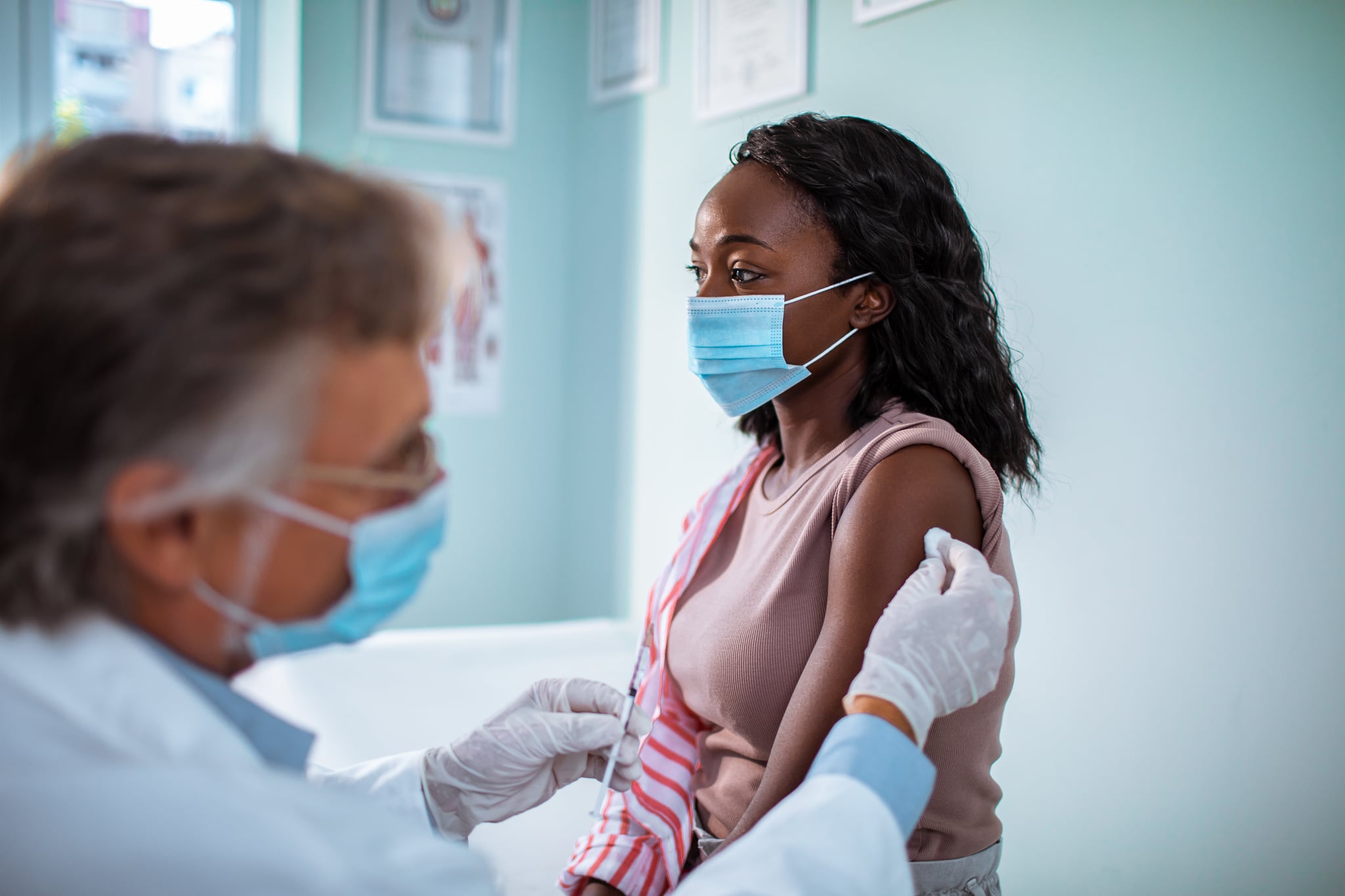 Close up of a young woman getting vaccinated