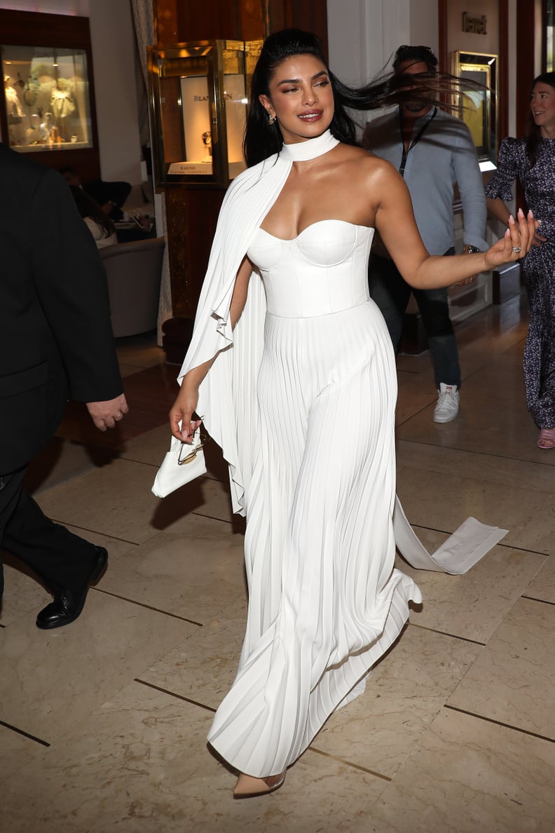 Priyanka Chopra Wearing a White Honayda Pleated Jumpsuit, Chopard Jewels, and Akris Bag at the Majestic Hotel