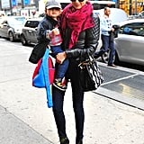 With son Flynn in hand, Miranda donned a mommy-on-the-go look with a Balenciaga quilted jacket, hot-pink pashmina, skinny jeans, Tabitha Simmons lace-up ankle boots, and a Prada bag adorned with floral appliqués.