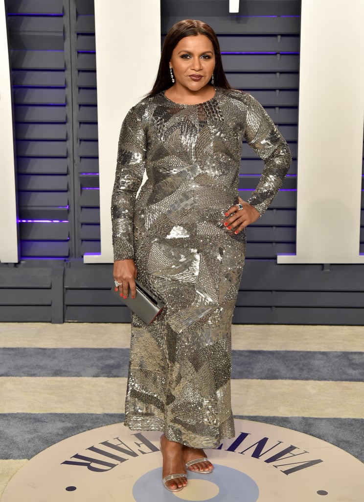 Kaling attended the 2019 Vanity Fair Oscars party in a shimmering Alberta Ferretti patchwork sequin dress, complete with a gunmetal box clutch, sapphire rings, diamond drop earrings, and silver sandals.