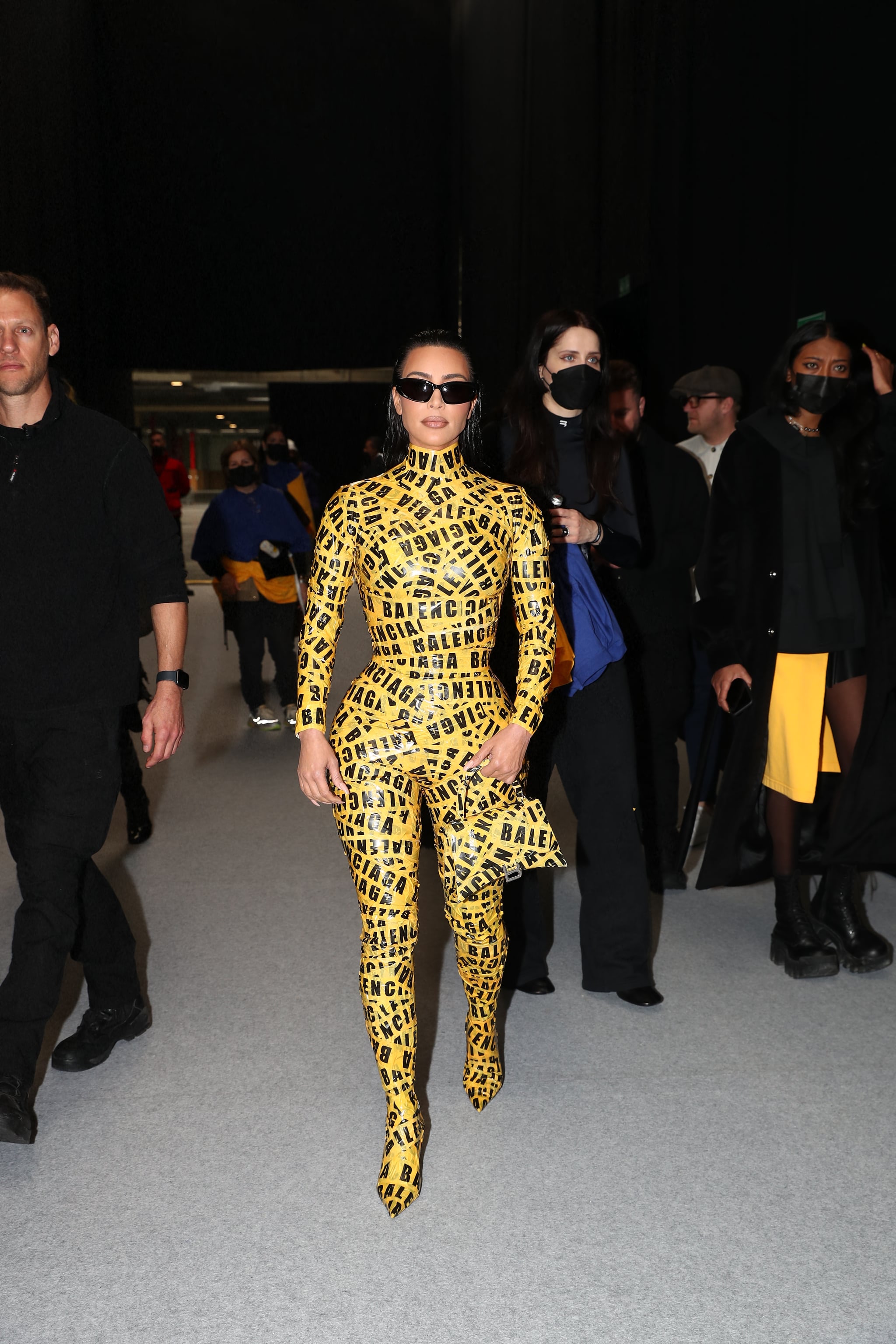 Kim Kardashian Attends Balenciaga Show in Yellow Caution Tape Catsuit