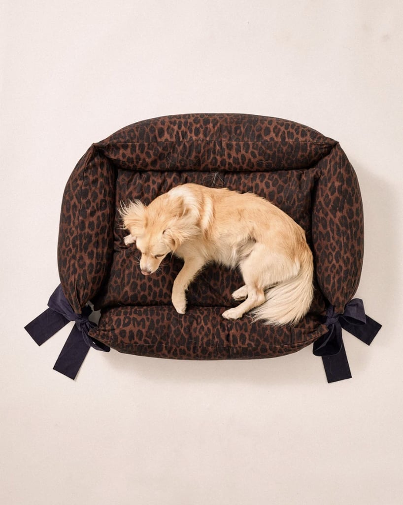 Damson Madder Dog Bed ($135)
"This luxurious leopard dog bed with oversize navy bows is too sweet. Whether you have a friend who recently got a new puppy or has had a dog for years, there's no doubt they'll love adding this decorative piece to their home. The comfy pillow cushion crafted from 100 percent organic cotton promises their furry friend will be obsessed too. You can even throw it in the wash in case of any messes." — Sarah Wasliak, shopping director and social host