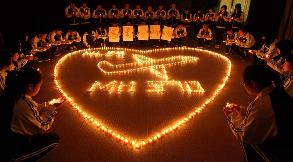 Students from an international school in China lit candles to pray for the passengers of Malaysia Airlines Flight MH370 in Zhuji, China.