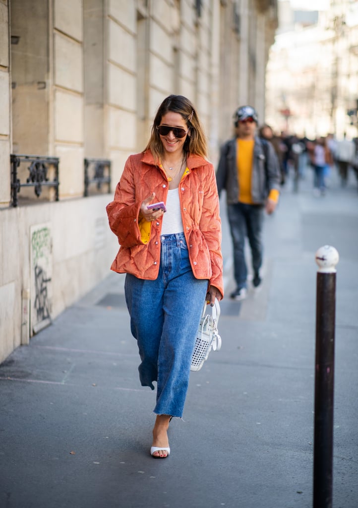 Style a white tank with wide-leg jeans and an orange jacket.