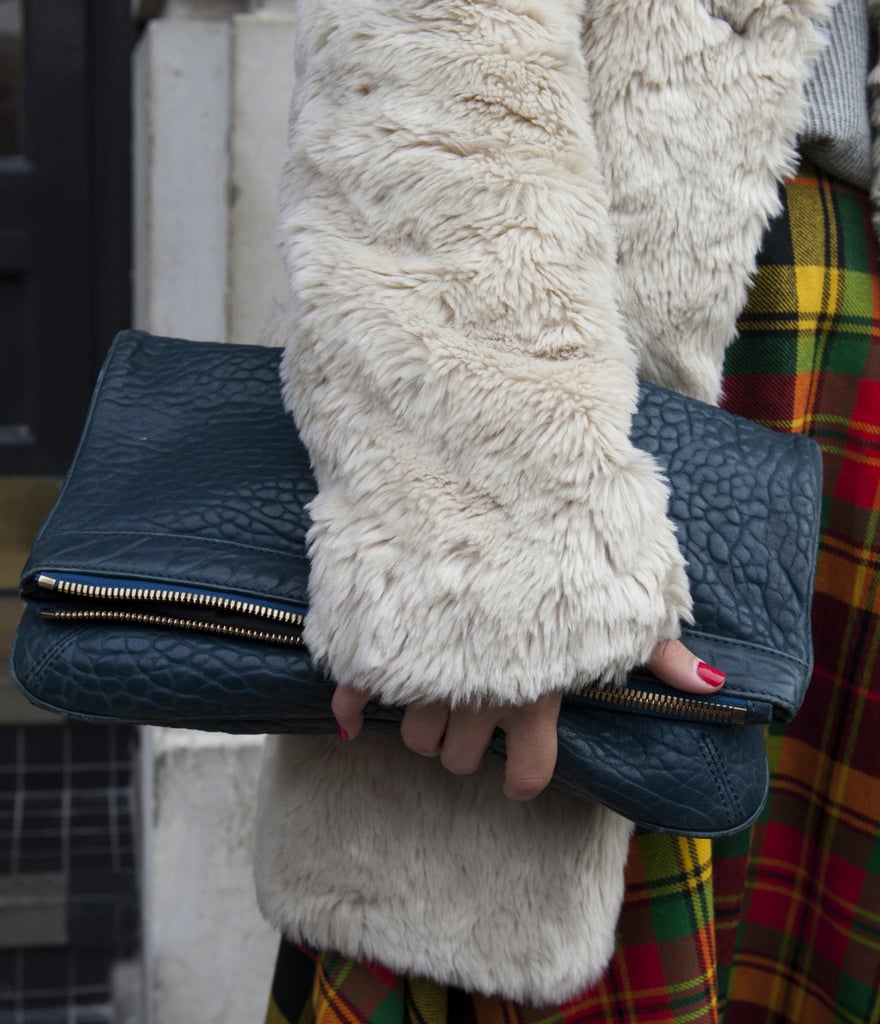 A textural fold-over clutch was paired with a fur coat and plaid trousers for a lesson in Winter layers.
A textural fold-over clutch was paired with a fur coat and plaid trousers for a lesson in Winter layers.