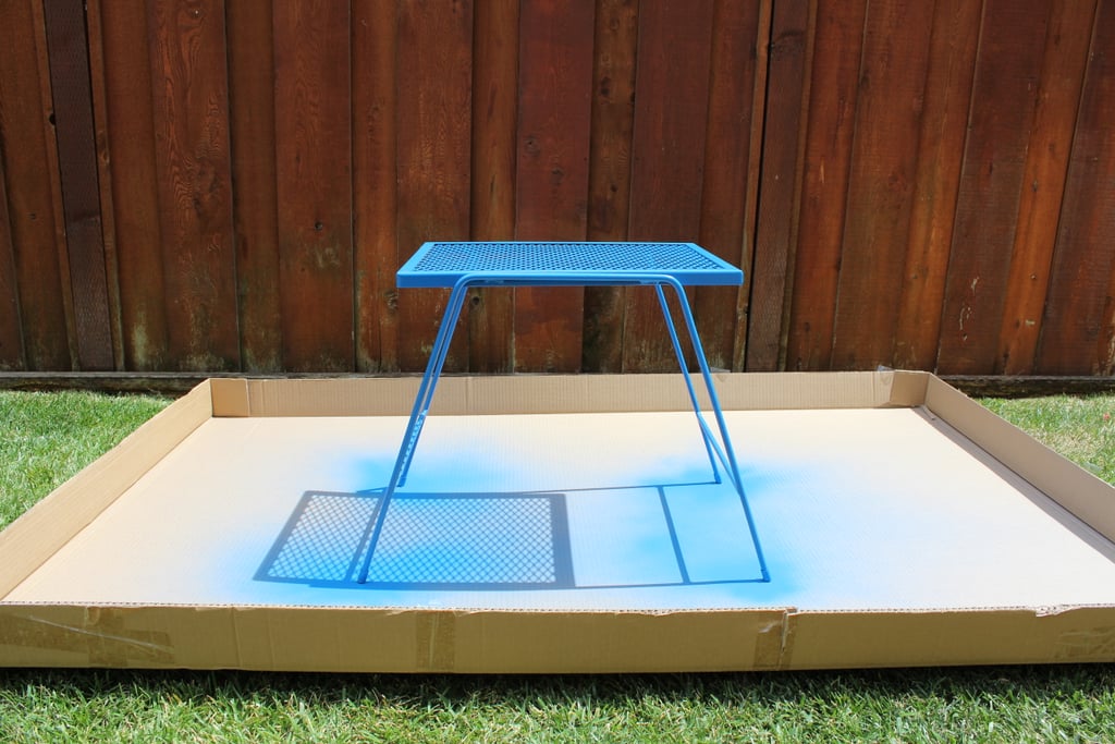 This plant stand from the hardware store looks a million times better coated with glossy blue spray paint. Bonus: it matches the rug! Just be sure to look for spray paint that is made for outdoor use.