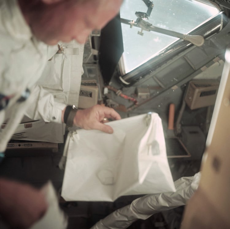 Here is Buzz Aldrin holding the bag 55 hours into the journey to the moon.