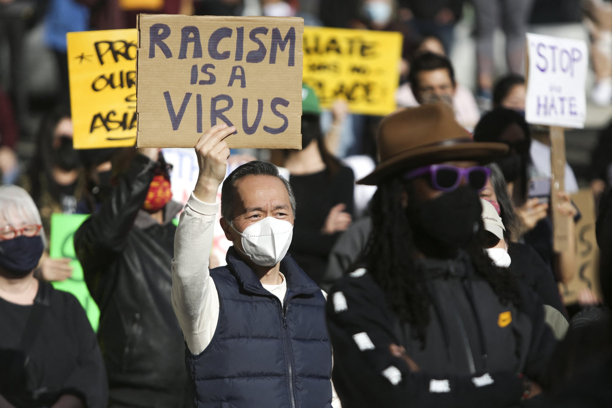 A man holds a sign that reads 