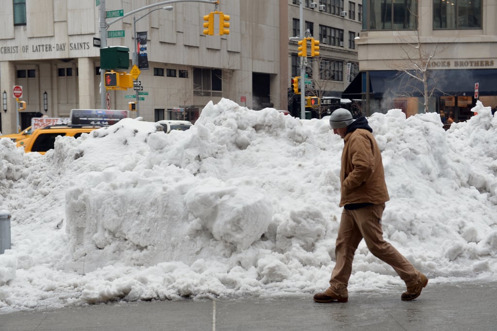 A huge pile of snow sat near the sidewalk in Manhattan.