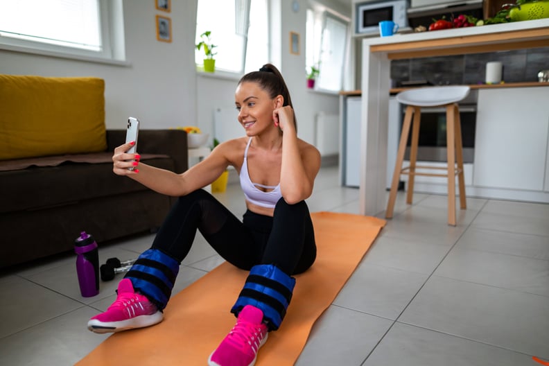 Woman using smartphone on break between exercise