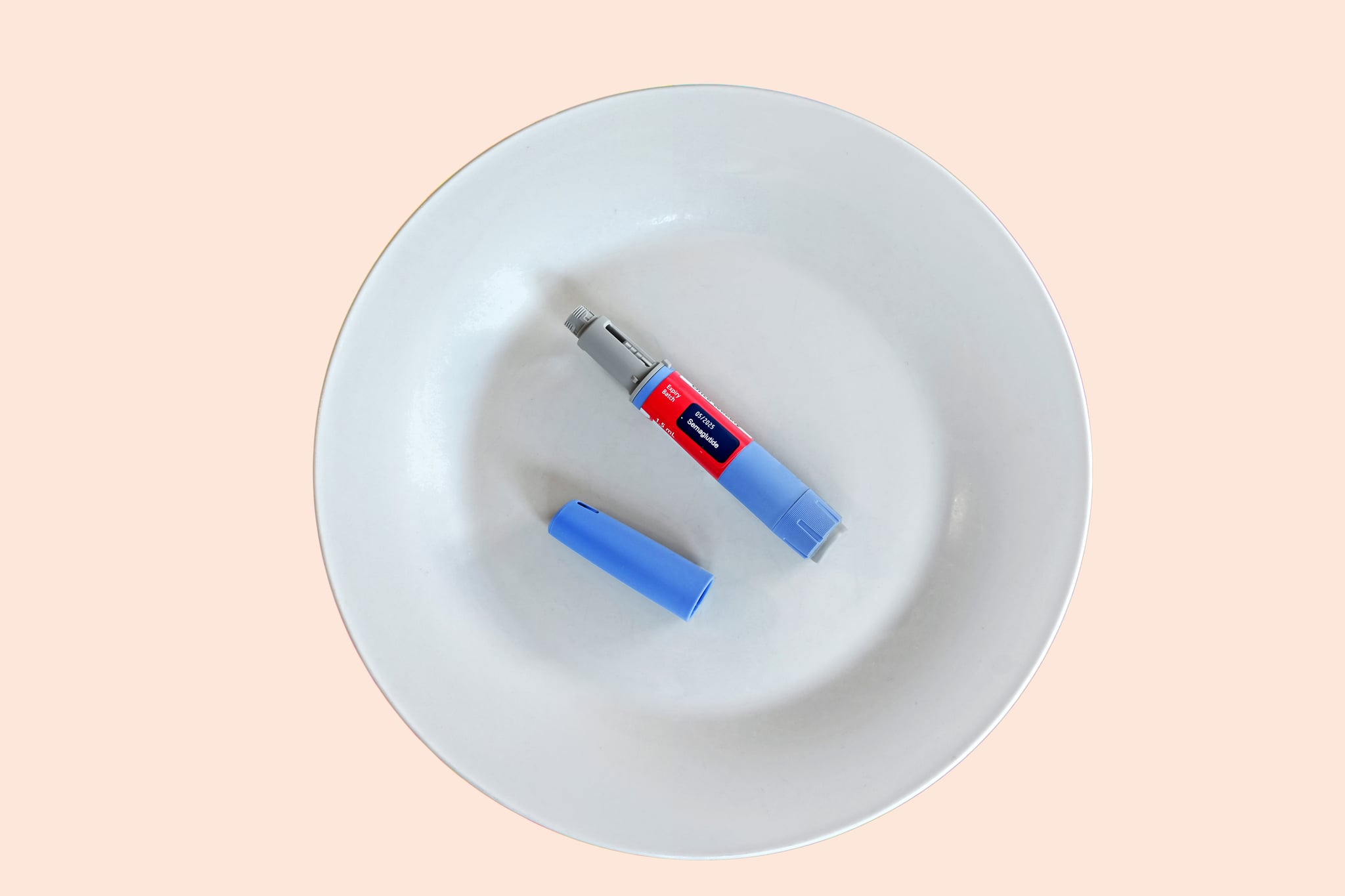 Semaglutide injecting  pen with lid on a white plate