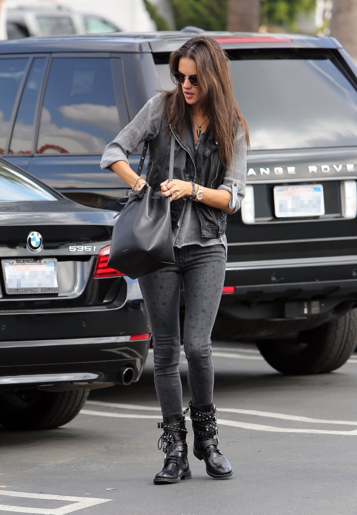 No high heels here! The model mom wore heavy buckled motorcycle boots and a leather vest while carrying a Mansur Gavriel bucket bag.