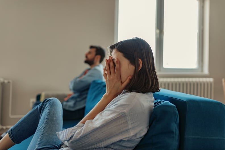 Unhappy Couple After an Argument in the Living Room at Home. Sad Pensive Young Girl Thinking of Relationships Problems Sitting on Sofa With Offended Boyfriend, Conflicts in Marriage, Upset Couple After Fight Dispute, Making Decision of Breaking Up Get Div