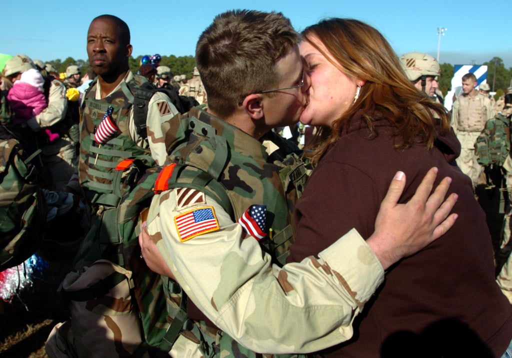 Meghan Gibson greets her fiancé, Spc. Aaron Evans, in 2006.
