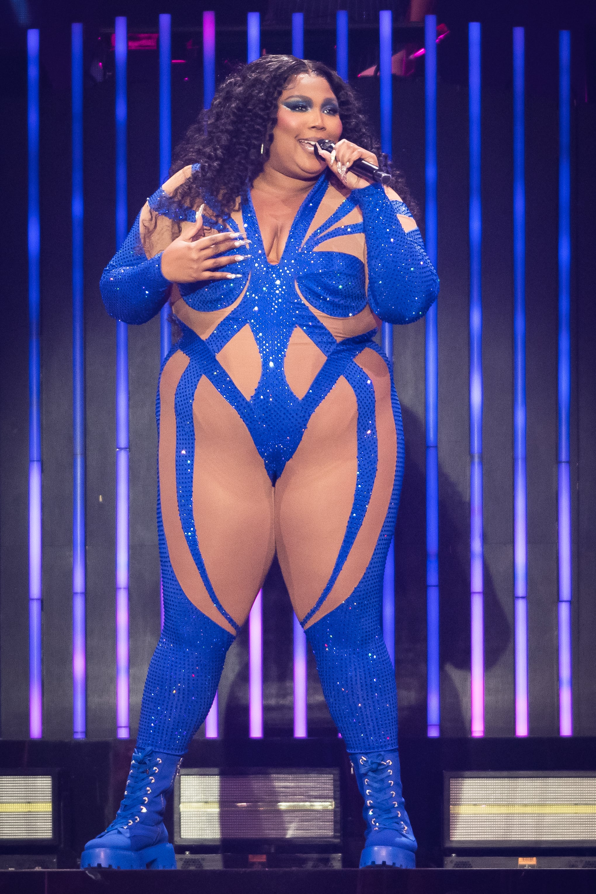 Lizzo dazzles in sparkling sexy leotard wrapped in festive red bow