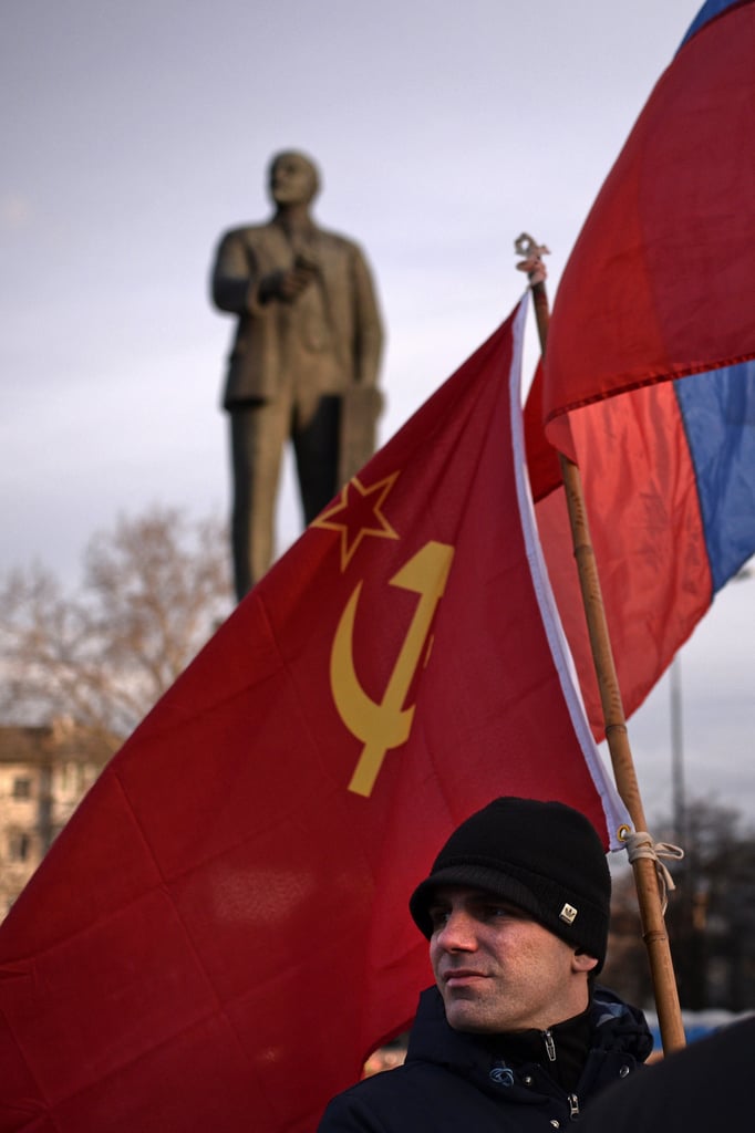 Pro-Russia residents also made their voices heard. In Simferopol, the capital of Crimea, a man held the flags of the Russian Federation and Soviet Union during a Saturday demonstration in the city's Lenin Square. Historically, the Crimean peninsula has changed hands many times, and it was a key part of the Soviet Union. But following the collapse of the USSR, it became part of independent Ukraine.
