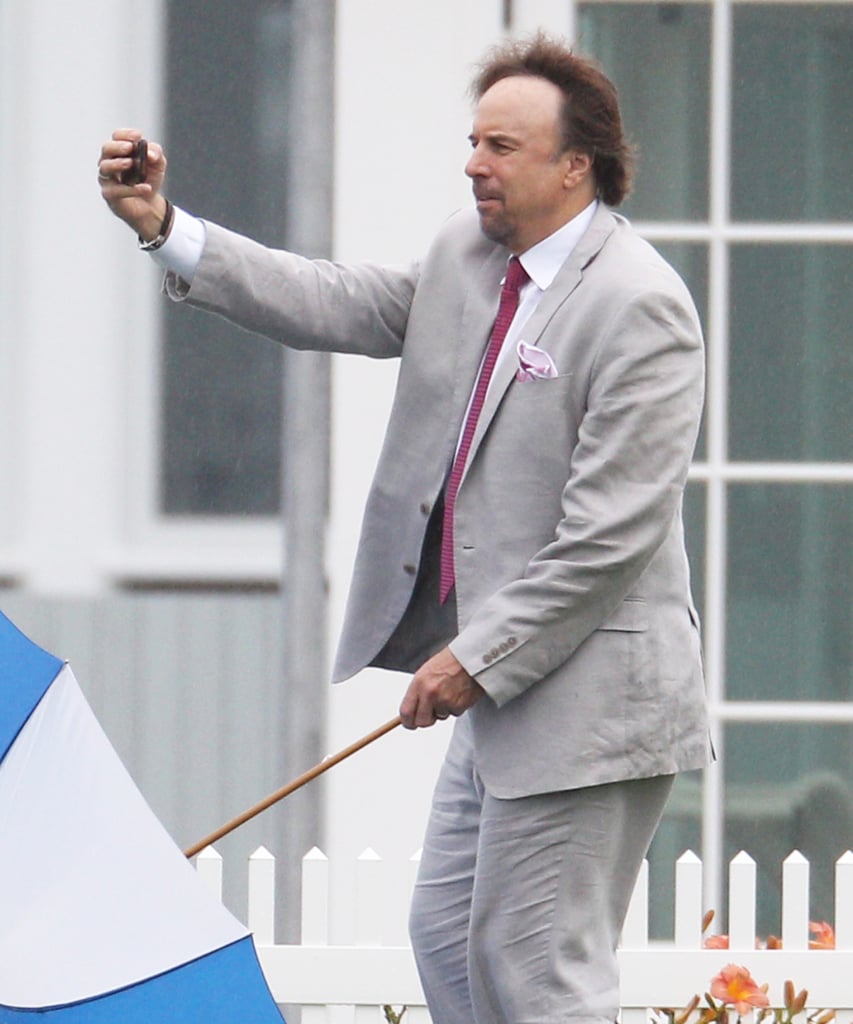 Kevin Nealon had to balance his umbrella and camera while snapping a selfie at Cheryl Hines and Robert F. Kennedy Jr.'s wedding at the famous Kennedy compound in Hyannis Port, MA, in August 2014.