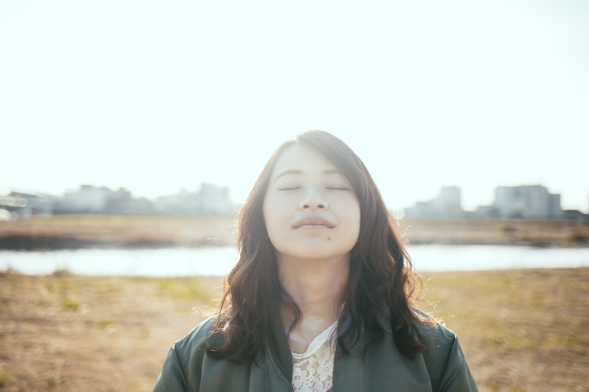 Asian woman calm and relaxed, improving her mental health.