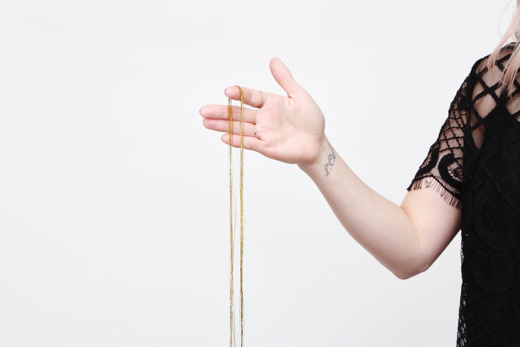 For this DIY, you'll need heat-resistant tinsel. (Classic tinsel is pretty on your Christmas tree but not cute when melted into your hair with a curling iron!) Bennett used La Demoiselle ($15 for 100 strands).