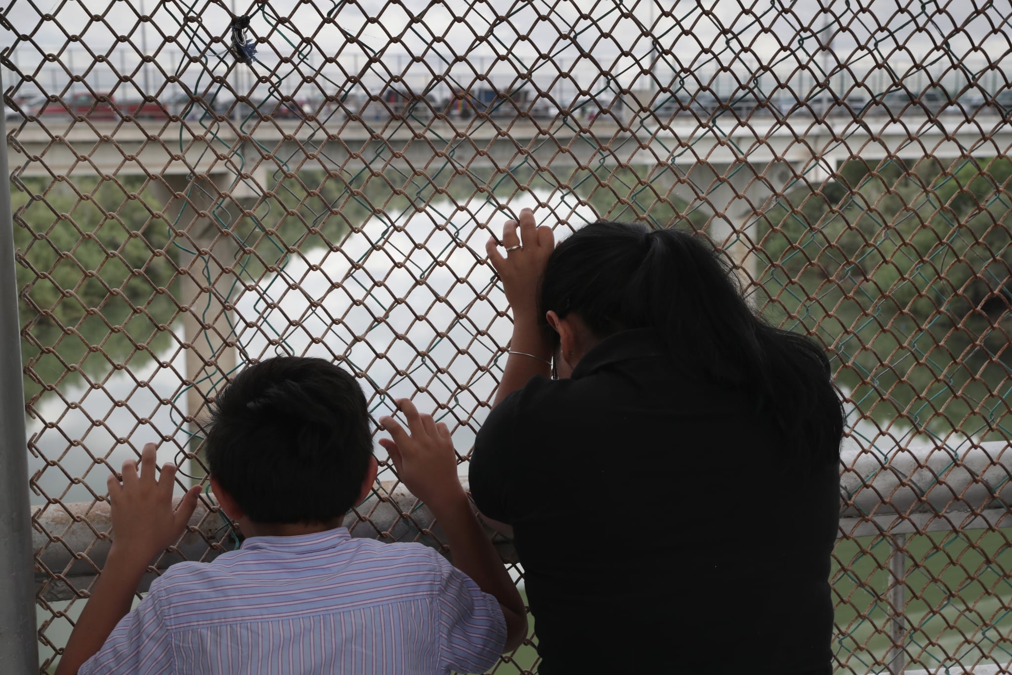 HIDALGO, TX - NOVEMBER 04:  Nicaraguan asylum seekers wait for entry into the United States while on the international bridge on November 4, 2018 in Hidalgo, Texas. President Trump ordered U.S. troops to border areas days before the midterm elections and weeks before the possible arrival of a caravan of immigrants from Central America.  (Photo by John Moore/Getty Images)