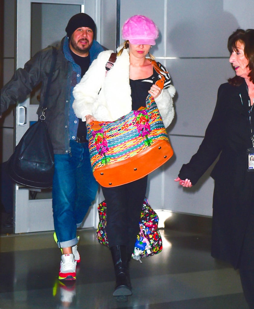 Back in January, Miley arrived at the airport in a colorful outfit that included the ring.