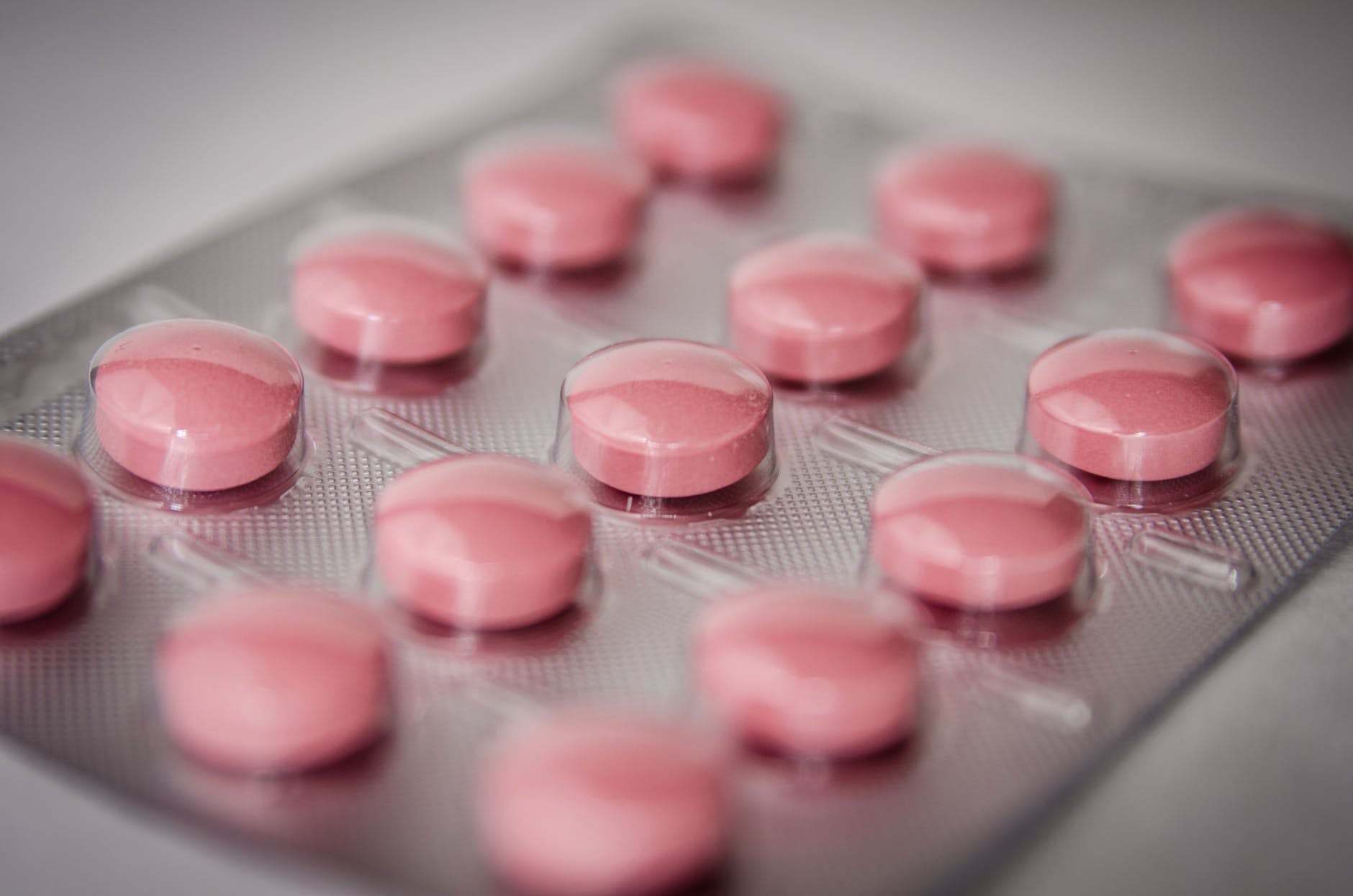 https://www.pexels.com/photo/pink-round-medication-pill-51929/