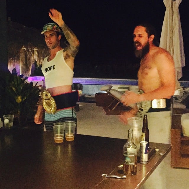 Behati Prinsloo took a photo of her husband playing beer pong (in a cropped shirt). 
Source: Instagram user behatiprinsloo