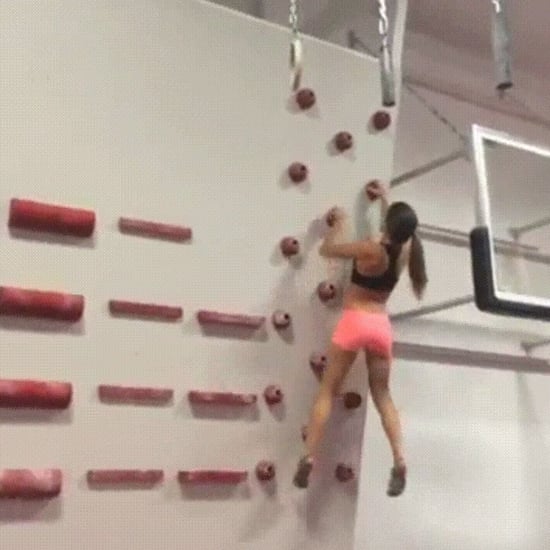 Female Rock Climber Using Campus Technique