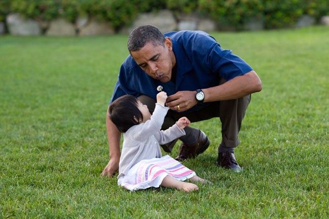 Proving his love for kids by bending down to blow a dandelion with his niece, Savita.