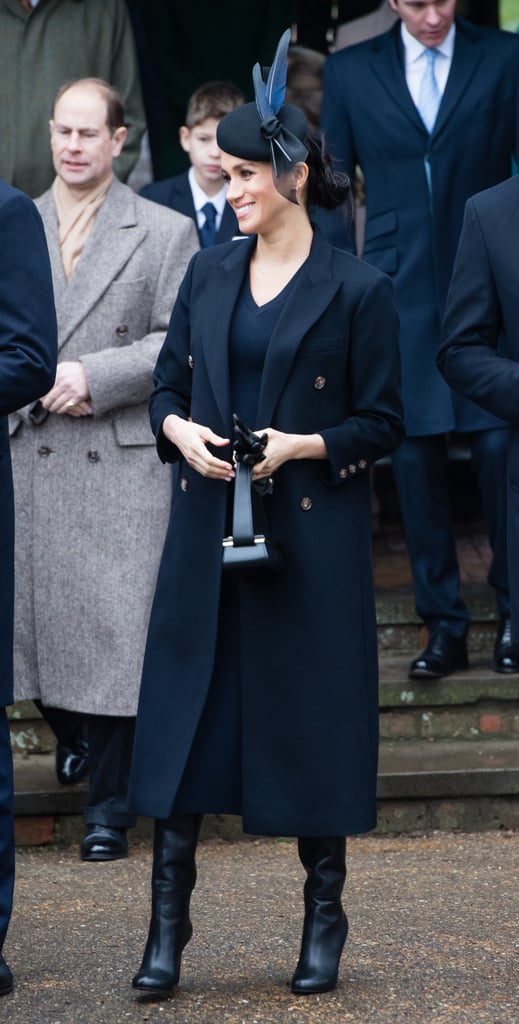 Meghan balanced darker accessories with navy blue Victoria Beckham separates on Christmas Day in 2018.