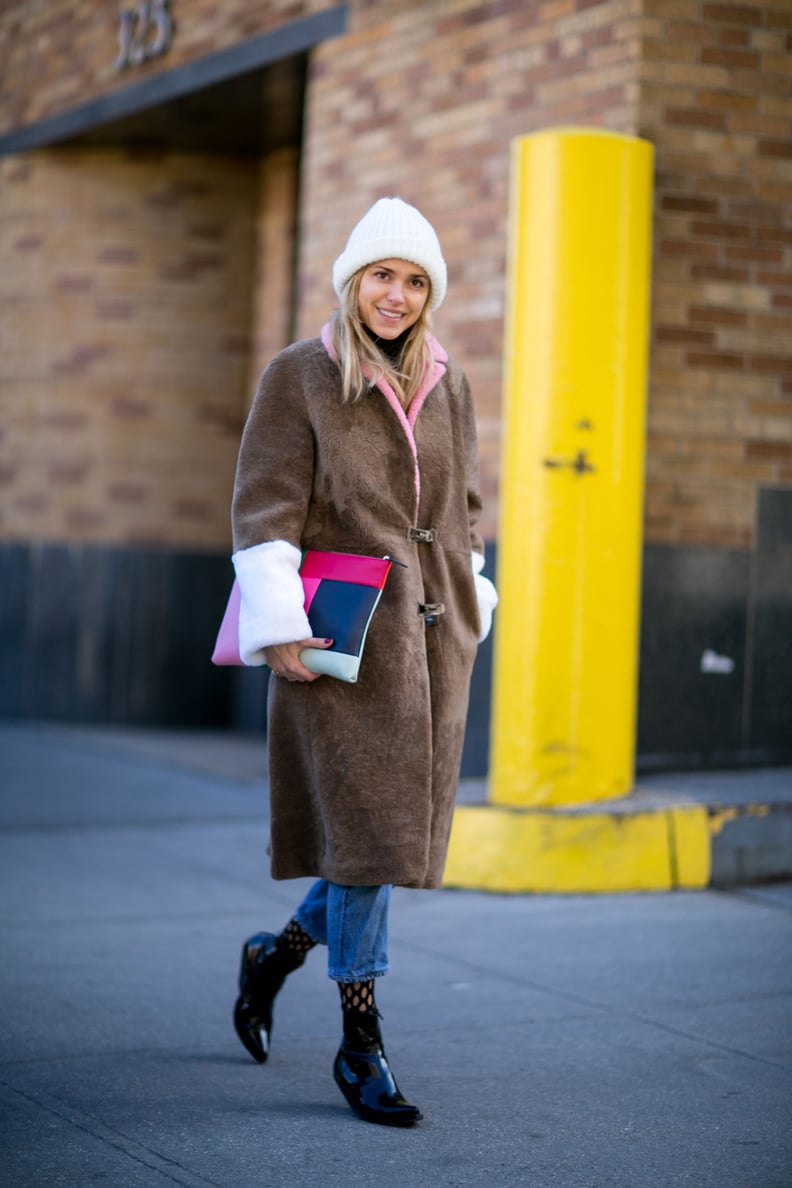 With a Brown Jacket, Fishnet Tights, and Black Boots