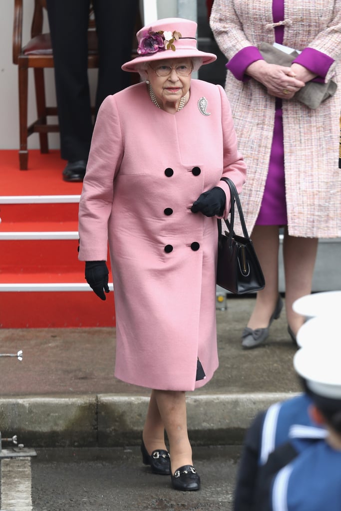 In March 2018, Queen Elizabeth II wore her trusty loafers with a pink coat and other black accessories.