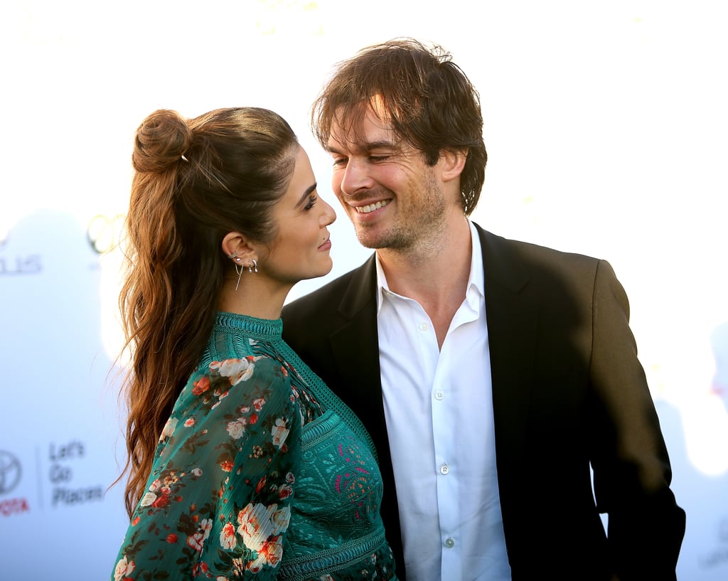 Nikki Reed and Ian Somerhalder looked so in love as they attended the Environmental Media Association Awards in Santa Monica, CA, on Saturday. The parents of daughter Bodhi showed sweet PDA as they posed on the red carpet and later presented together on stage during the ceremony. Their carefree outing comes on the heels of their recent public apology for their controversial comments about starting a family. During an interview with Dr. Berlin's Informed Pregnancy podcast (which has since been deleted), Nikki explained that Ian went into her bag and threw out her birth control pills during their trip to Barcelona, Spain, in 2016. 
While Nikki responded to the backlash with an impassioned post shortly after, the couple made a joint statement on their respective Twitter accounts on Saturday apologizing for their comments. "To anyone who has been affected by reproductive coercion, we are deeply sorry," they wrote. "We never expected a lighthearted interview we did poking fun at EACH OTHER and how WE chose together to get pregnant, a goofy moment in Barcelona with our two best friends and the anticipation of our journey together as we went from two to three, to turn into something representing a very serious matter. We are two happily married people who chose TOGETHER to have a baby. The end."