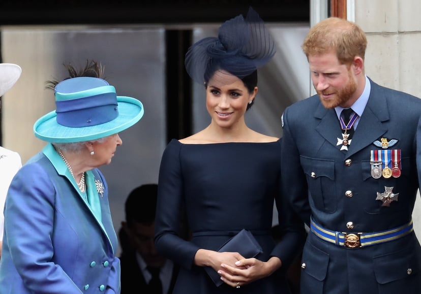 LONDON, ENGLAND - JULY 10:  (L-R)  Queen Elizabeth II, Meghan, Duchess of Sussex, Prince Harry, Duke of Sussex watch the RAF flypast on the balcony of Buckingham Palace, as members of the Royal Family attend events to mark the centenary of the RAF on July