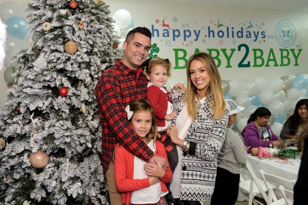 The family cuddled up at the Baby2Baby holiday party in December 2014.