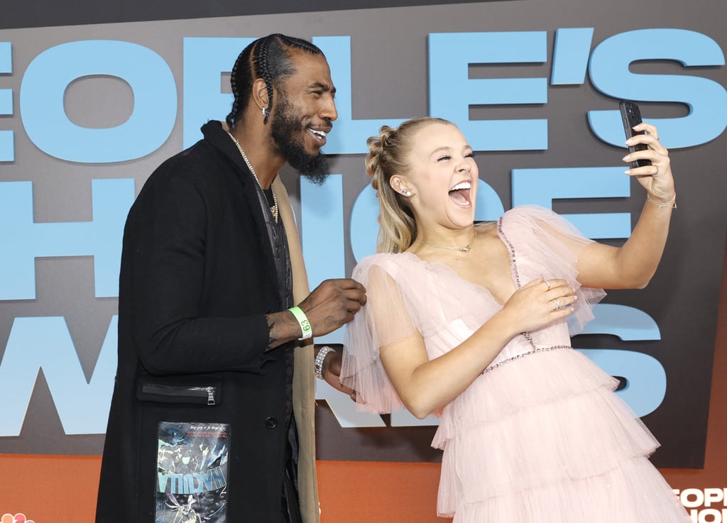 The latest season of Dancing With the Stars may have wrapped weeks ago, but JoJo Siwa and Iman Shumpert are staying in touch. The two competitors reunited at the 2021 People's Choice Awards on Dec. 7, posing for photos on the red carpet and laughing as they took selfies. 
JoJo and Iman both had an impressive DWTS run, with JoJo being runner-up and Iman winning the whole thing. "I never thought I'd have a ballroom trophy," Shumpert told Entertainment Tonight after his win. "My mom wasn't able to come to the building, but I can't wait to put this in her hands so she can get a chance to enjoy this, because this is a tremendous honor to be part of such a brand." JoJo, meanwhile, made history by being part of the first same-sex dancing pair on the show. 
See photos of their red carpet catchup ahead.

    Related:

            
            
                                    
                            

            JoJo Siwa&apos;s Style Is Evolving Before Our Eyes! See Her Pink People&apos;s Choice Awards Dress