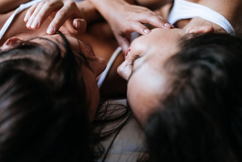 Two People in Bed Touching Each Other's Faces 