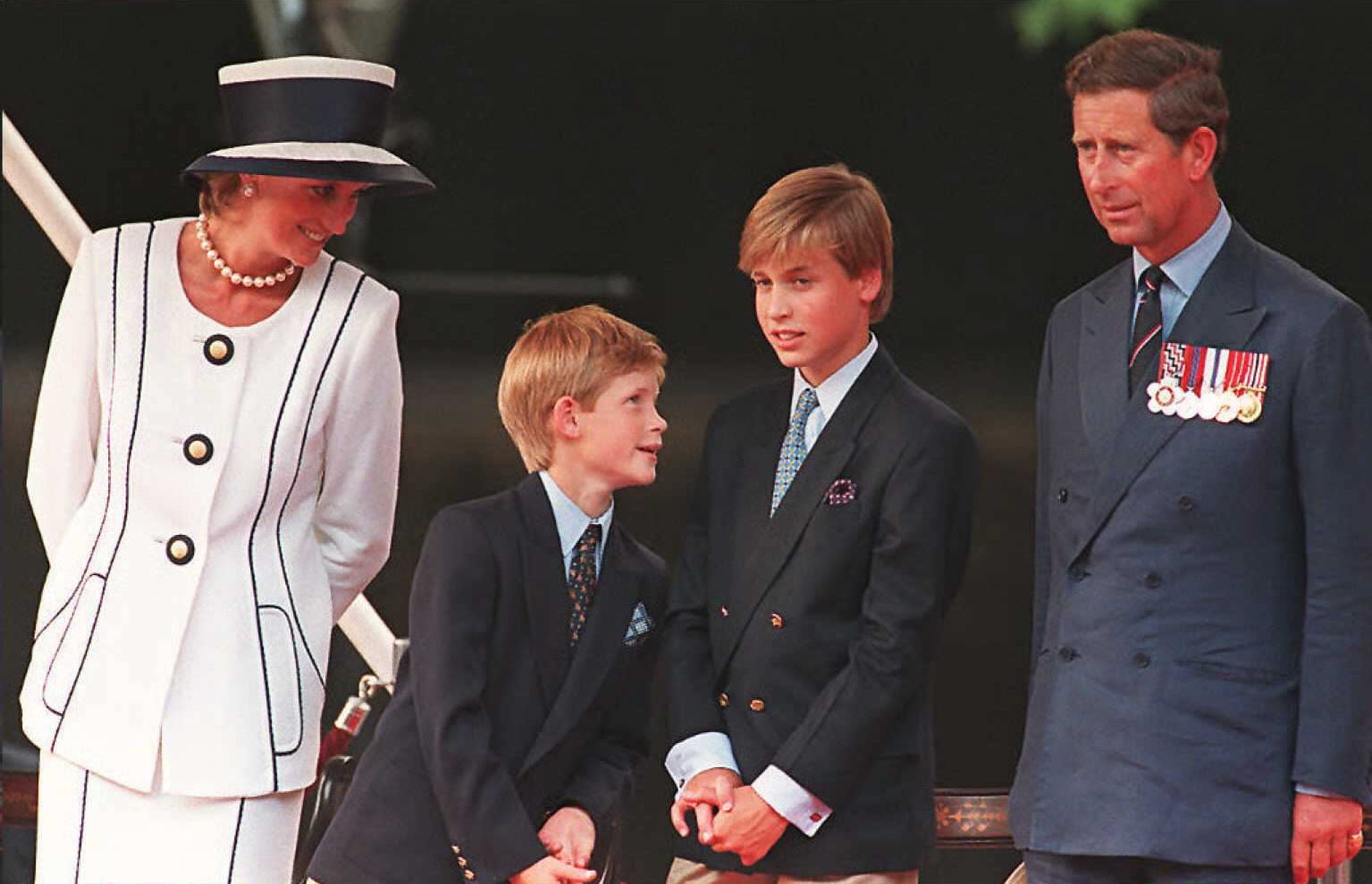 Princess Diana(L), her sons Harry(2nd L) and William(2nd R), and Prince Charles(R) watch the parade march past as part of the commemorations of VJ Day 19 August in London. The commemoration was held outside Buckingham Palace and was attended by 15,000 veterans and tens-of-thousands of spectators.  AFP PHOTO (Photo credit should read JOHNNY EGGITT/AFP/Getty Images)