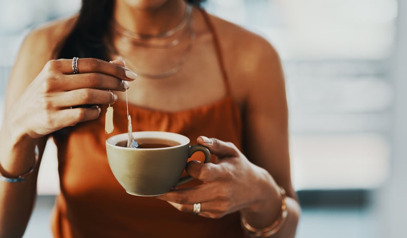 Cropped shot of a woman having a tea break at home