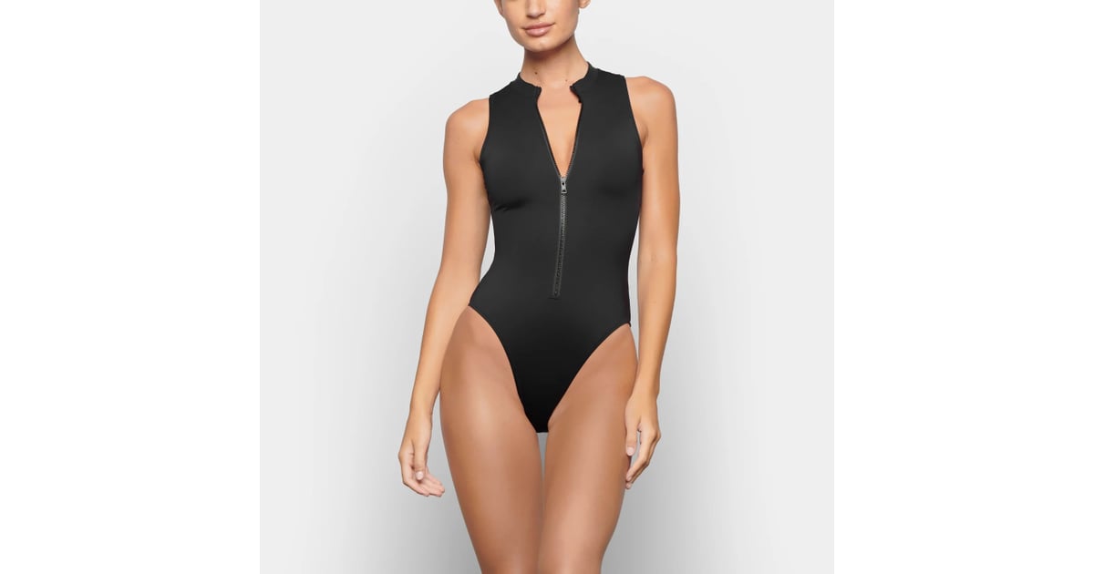 Skims Swim Zip Front Sleeveless One Piece in Onyx, Kim Kardashian Wears a  Plunging, Zip-Front Swimsuit For a Day on the Lake