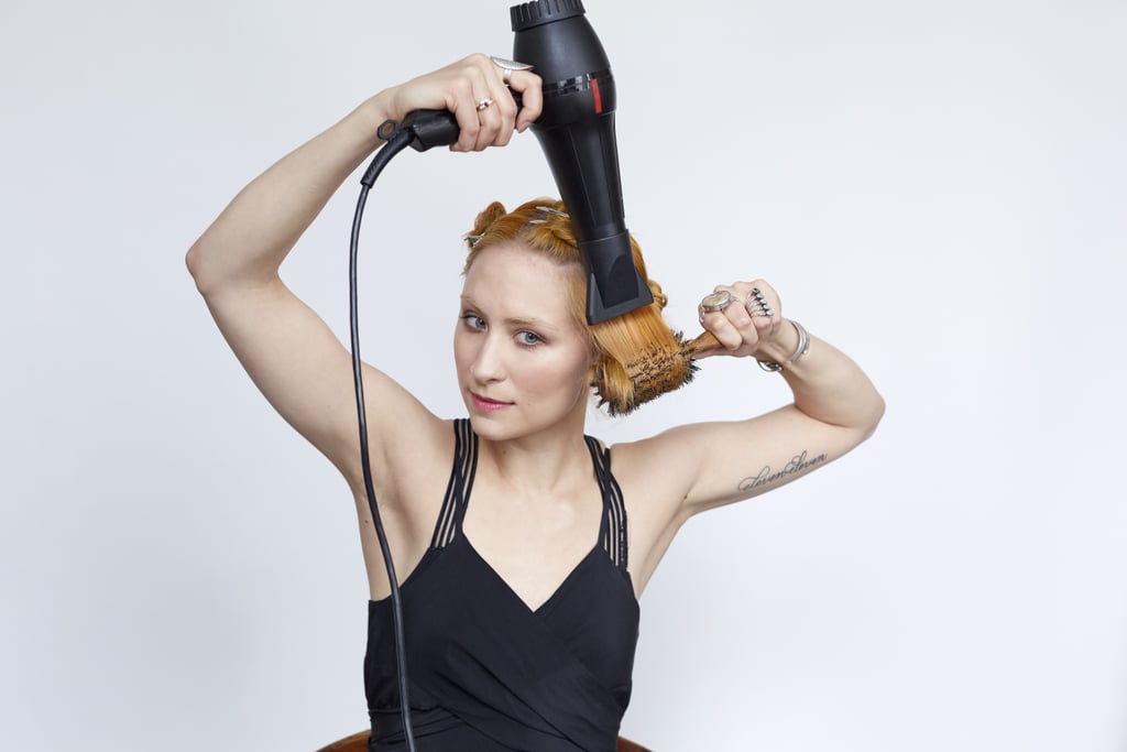 Divide your fourth section in half; twist and secure one half, and put it away. With the remaining half, begin to blow-dry with a round brush, carefully rolling hair up and back down the brush while directing the dryer down the hair shaft.