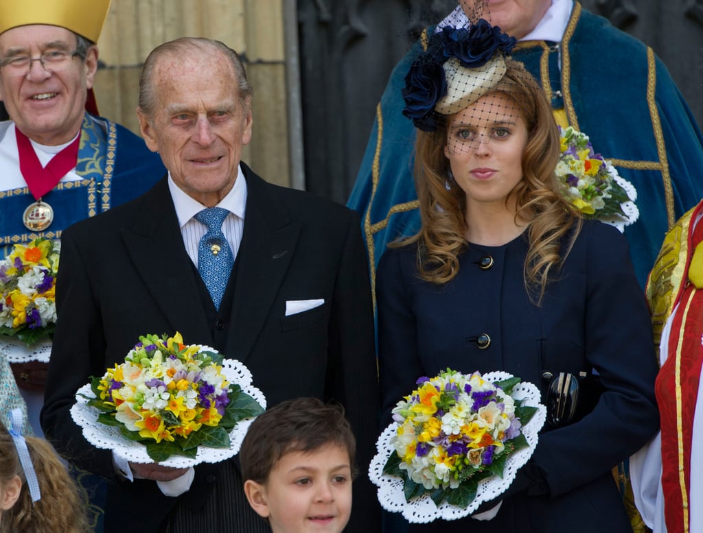 Philip and Princess Beatrice held on to flower bouquets after church service in April 2012.